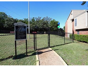 a yard with a chain link fence and a sign at Great Hills, Austin, TX